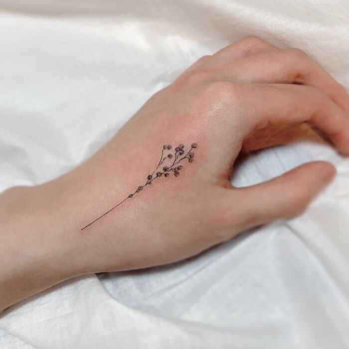 Flower branch tattoo on arm