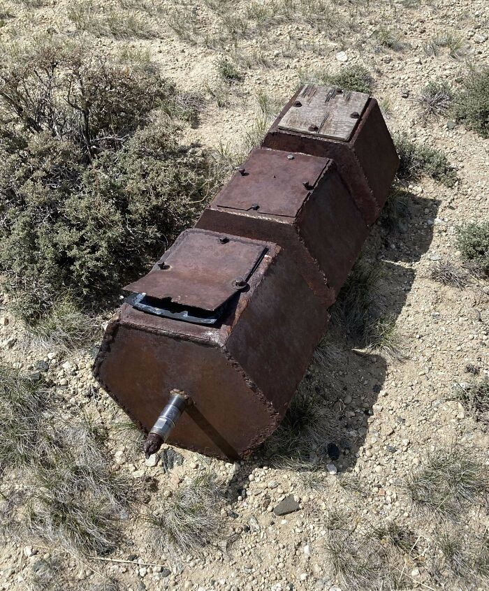 Large, Heavy Metal Hexagonal Object Found In Central Wyoming. It Has 3 Hollowed-Out Containers Each Attached To A Central Pipe. The 'Lids' On Top Are Bolted Shut