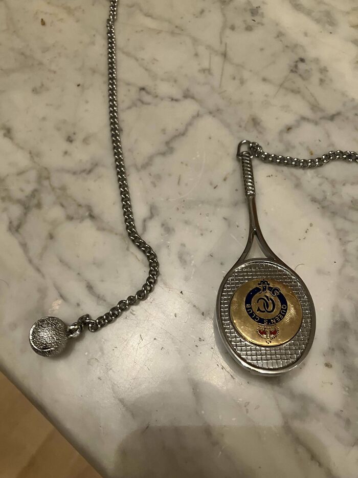 Tennisracket With A Hook On The Back, On A Long Chain With Ball At The End. Looks Like Merchandise, But What Is The Hook And The Chain With The Ball For?
