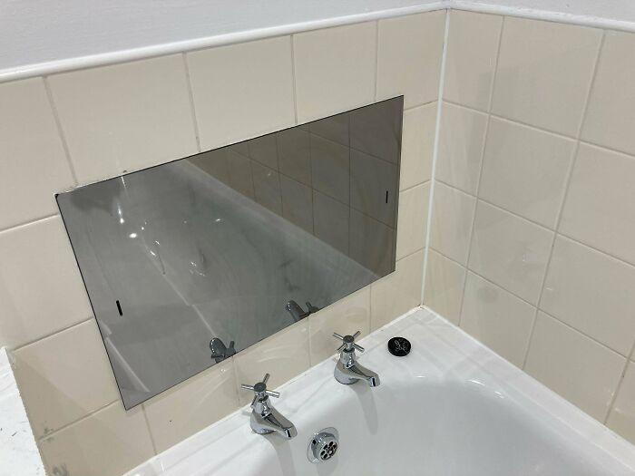 What Is This Strange Mirrored Panel Above The Bath In My New UK Apartment?