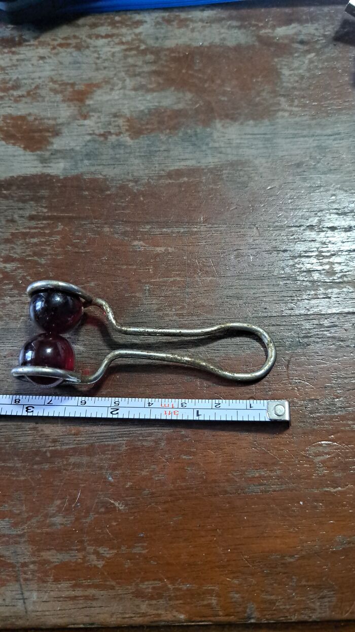 Metal Spring Thing With 2 Red Glass Balls. Can Be Separated, The Balls Do Come Out. Little Over 3 Inches. Looks Like A Pair Of Tongs Holding The Red Balls