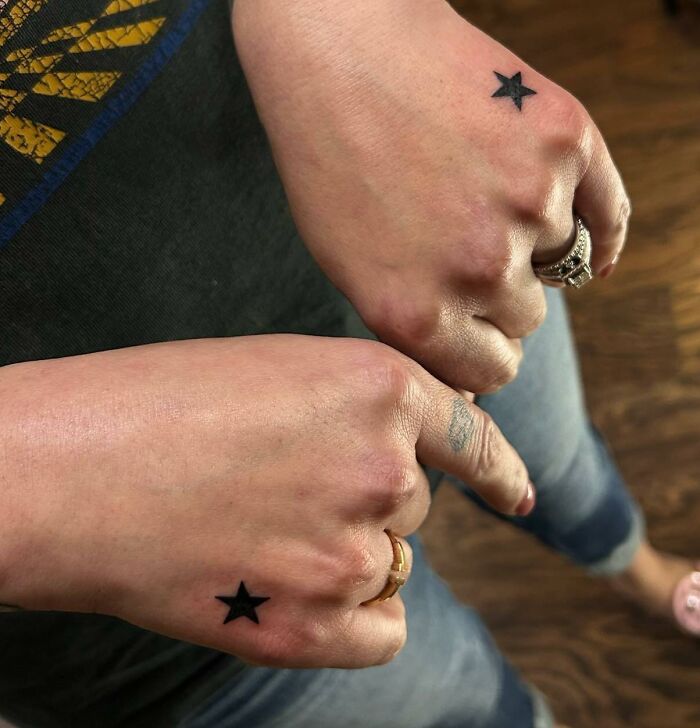 Black star tattoo on hands