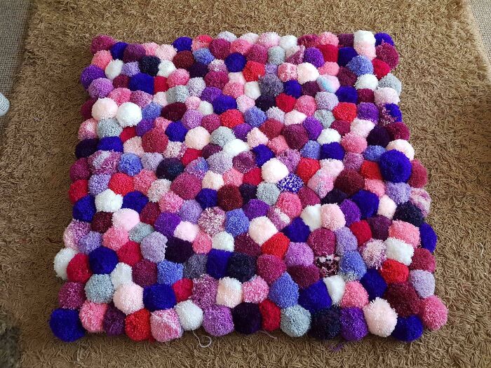 Colorful rug with poms