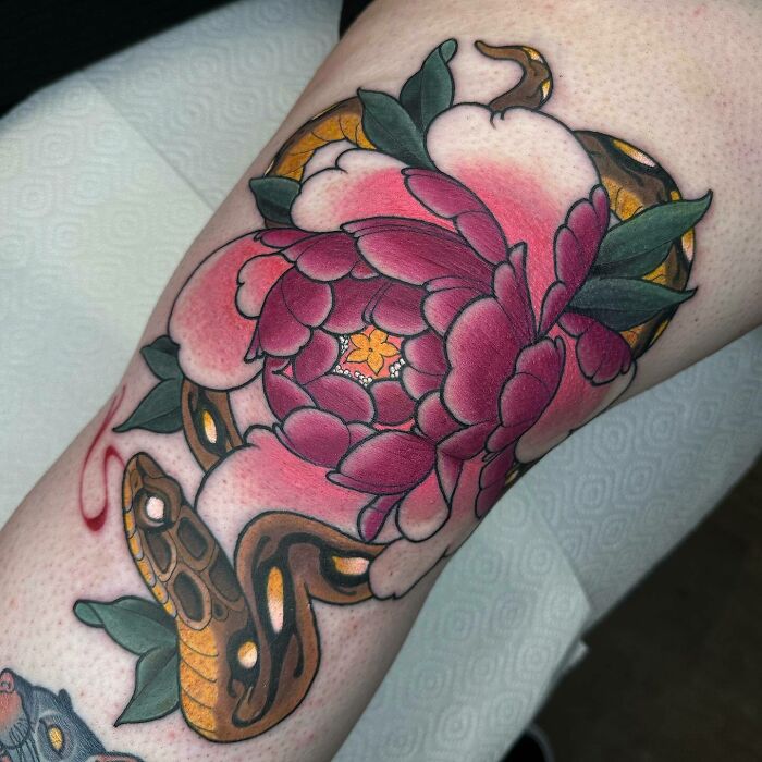 Pink flower with snake tattoo