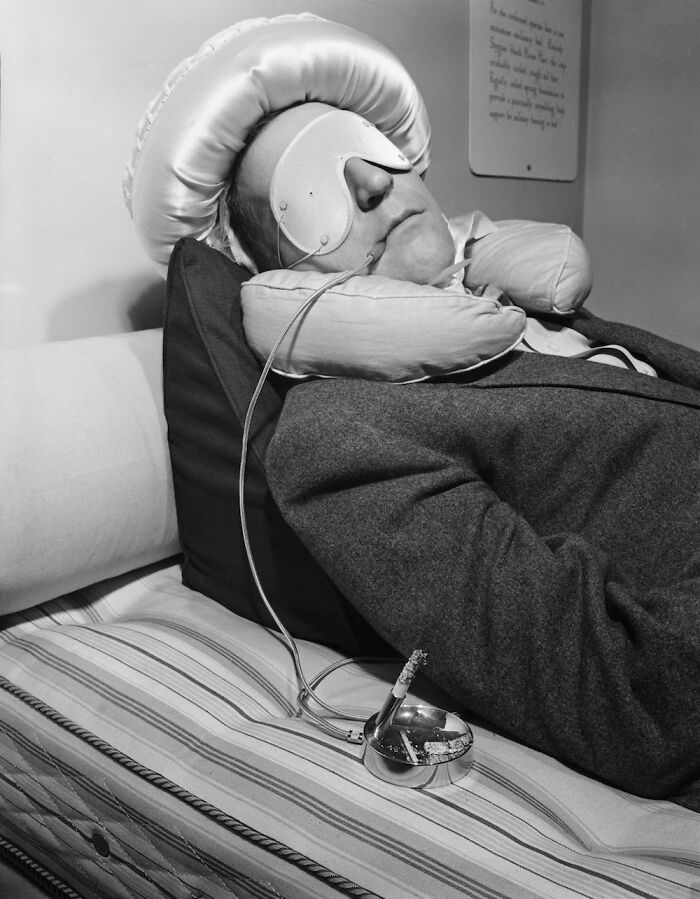American Entertainer Garry Moore Trying Out A Special Contraption For Smoking To Forestall Burning Bedclothes Should He Fall Asleep With The Cigarette Still Lit, 1953