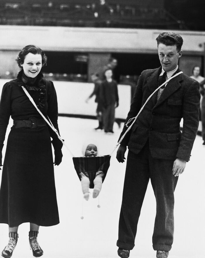 Jack Milford, Player With The Wembley Monarchs Ice Hockey Team, Invented A Carrying Device So That His Baby Can Join His Wife And Himself On The Ice, 1937