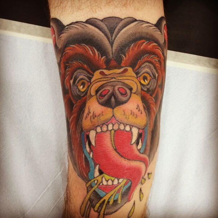 Grizzly bear with tongue out knee tattoo