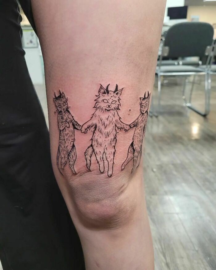 Three cats dancing and holding paws tattoo 