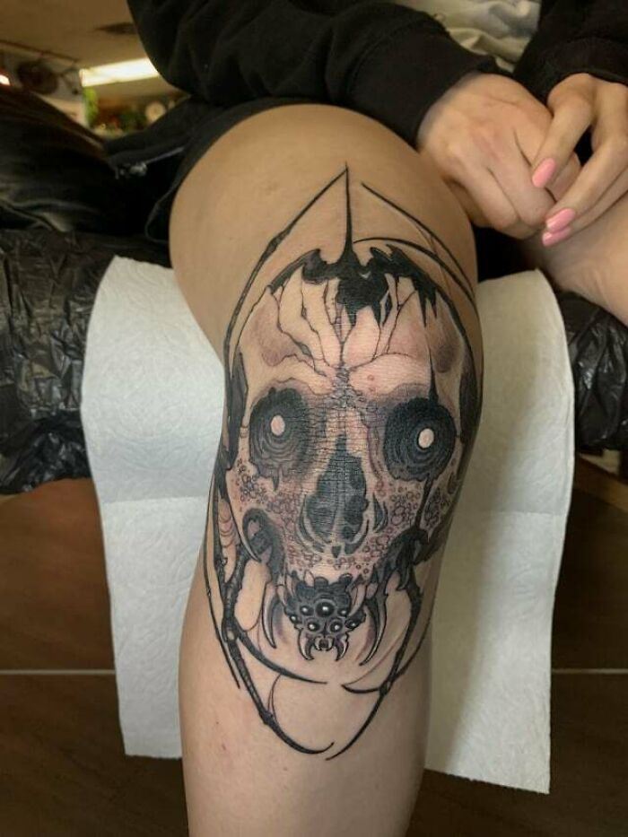 Cracked skull with spider coming out of it tattoo 