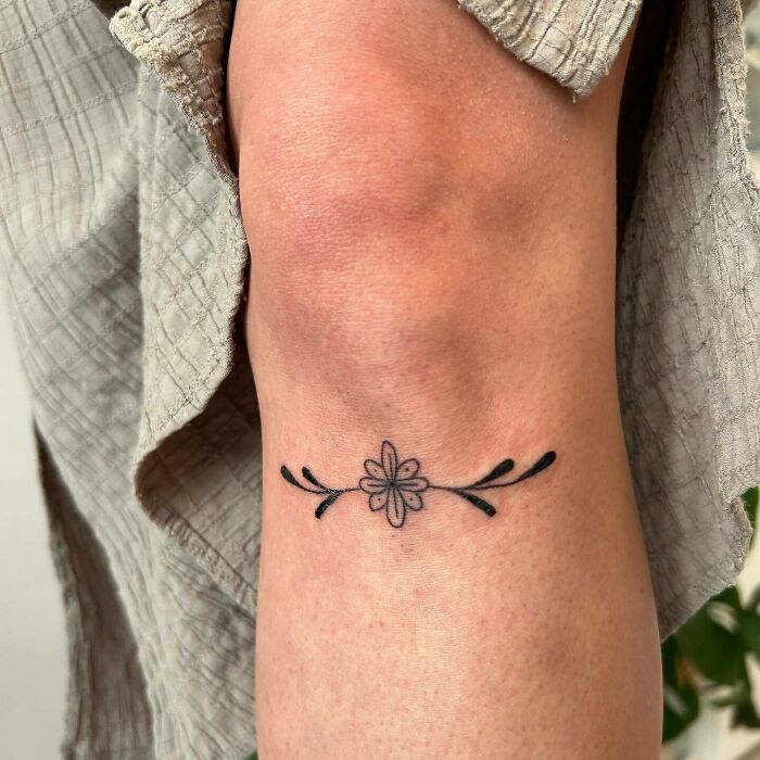 Small flower knee tattoo 