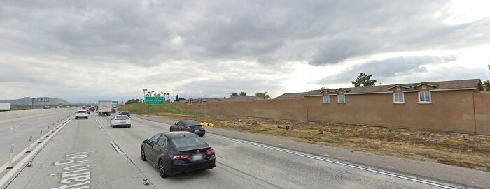 Houses Combined With The Wall Next To A Freeway. So Depressing