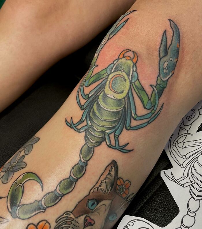 Green scorpion knee tattoo 