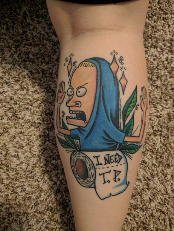 Cornholio wearing blue shirt leg tattoo