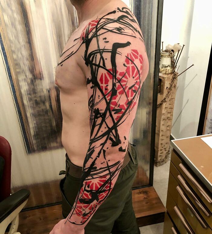 Abstract arm sleeve tattoo
