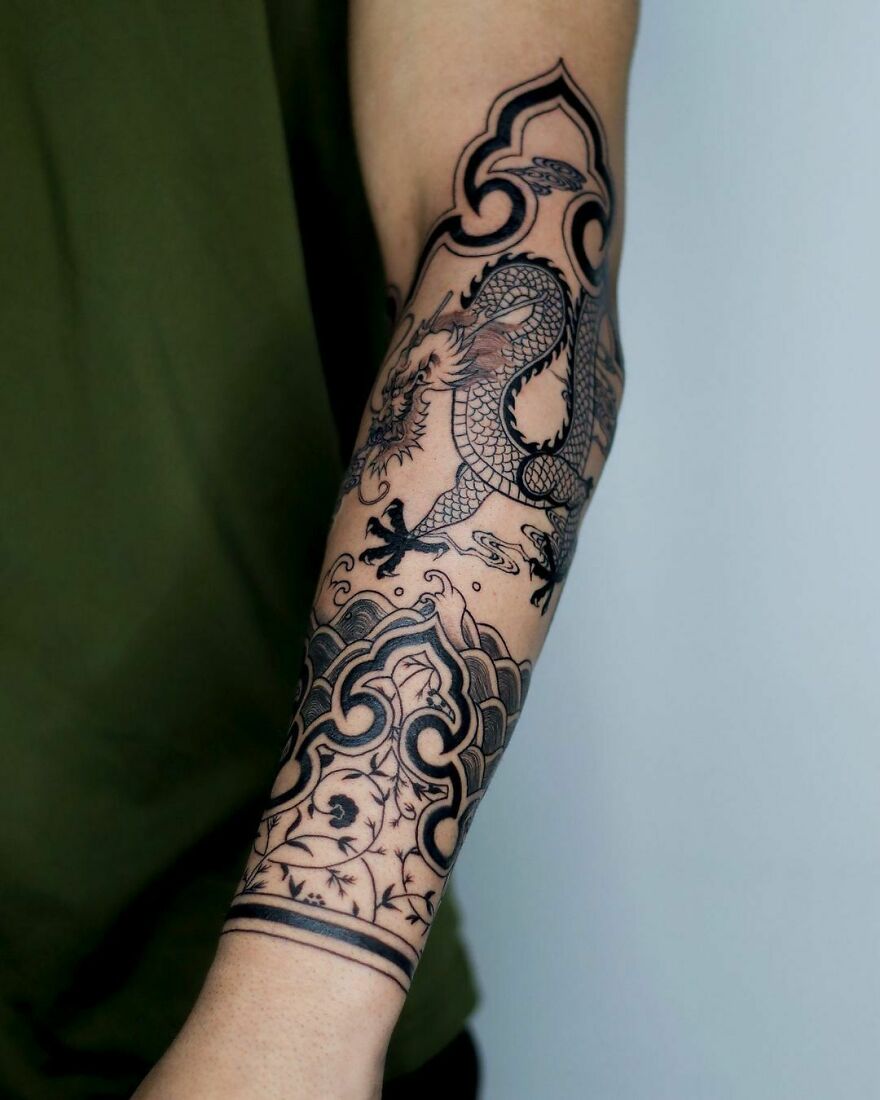 black ink dragon tattoo with ornamental decorations 