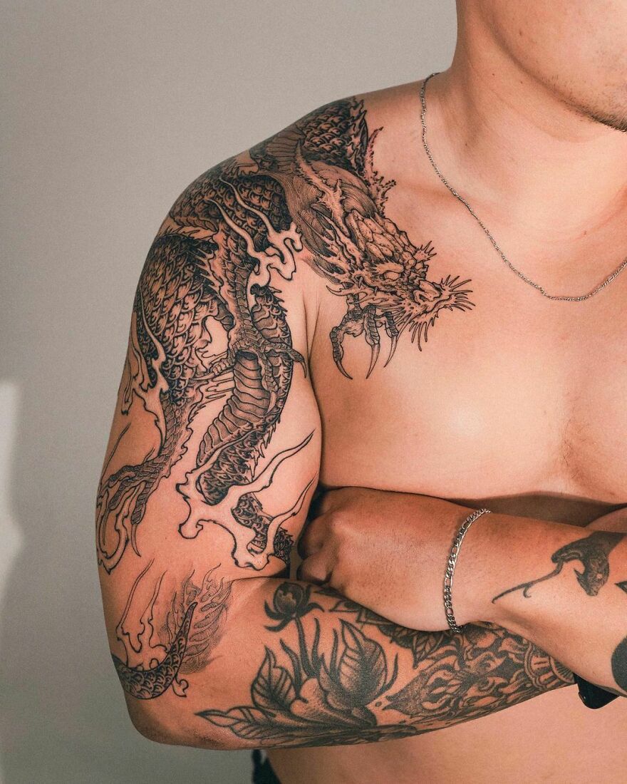 Tattoo Of A Dragon On Entire Sleeve In Black Ink