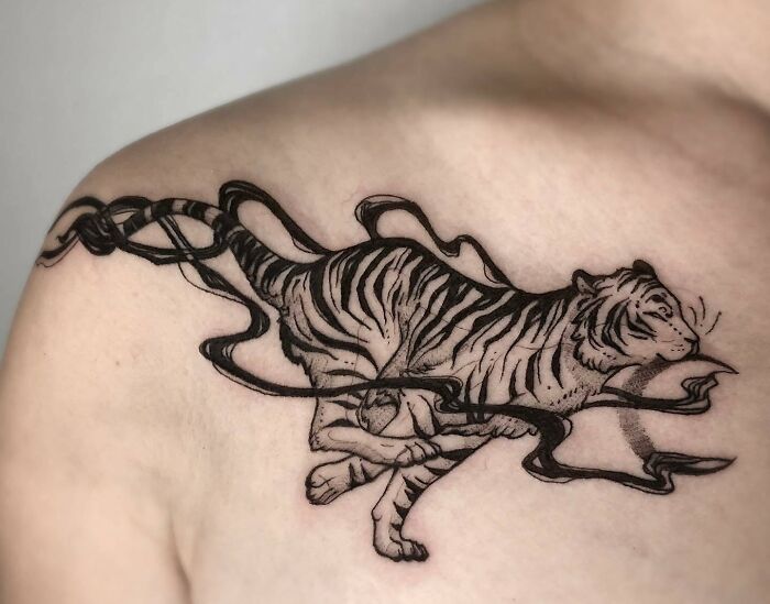 Running tiger with black smoke tattoo