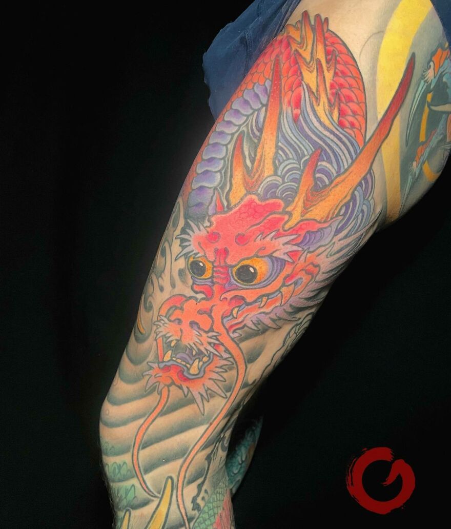 red face colorful dragon tattoo looking downwards 