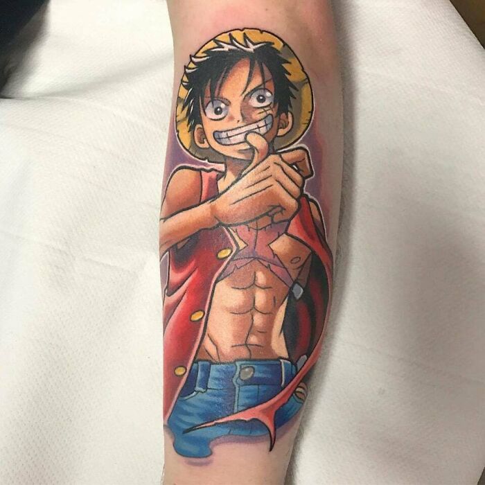 Luffy smiling and wearing red shirt and hat From One Piece Tattoo