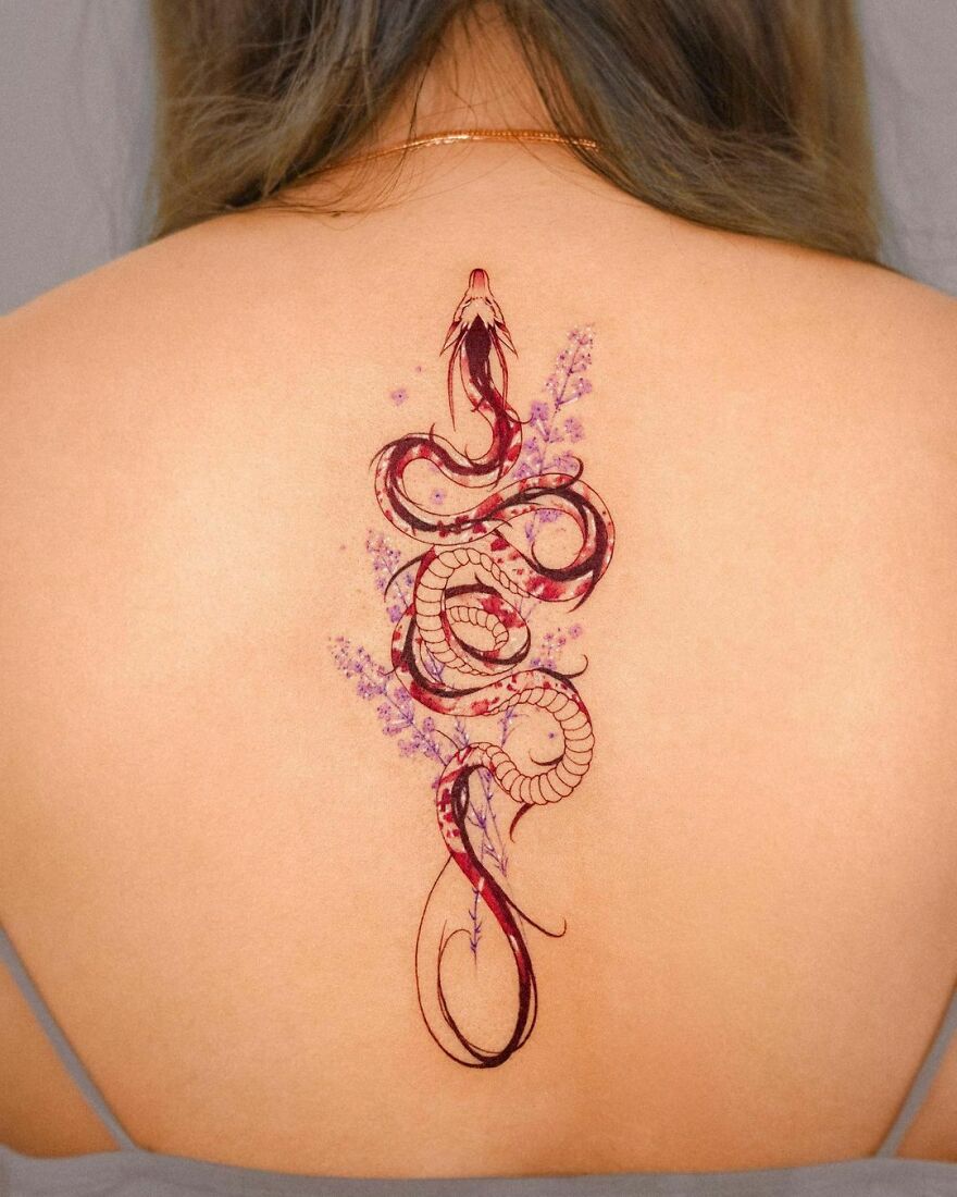 Back tattoo design of a Haku Dragon on the back in red ink with lavenders 