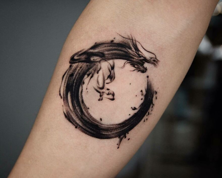 black ink circular design tattoo of a dragon