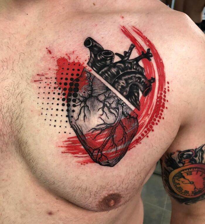 Trash Polka tattoo of a heart with red and black ink patterns on a person's chest.