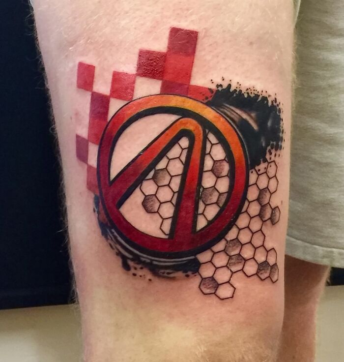 Trash Polka tattoo featuring red and black geometric shapes with honeycomb pattern on a person's arm.