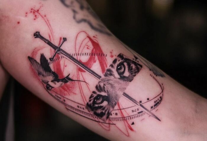 Thailand Trash Polka style tattoo with tiger eyes, bird and sword