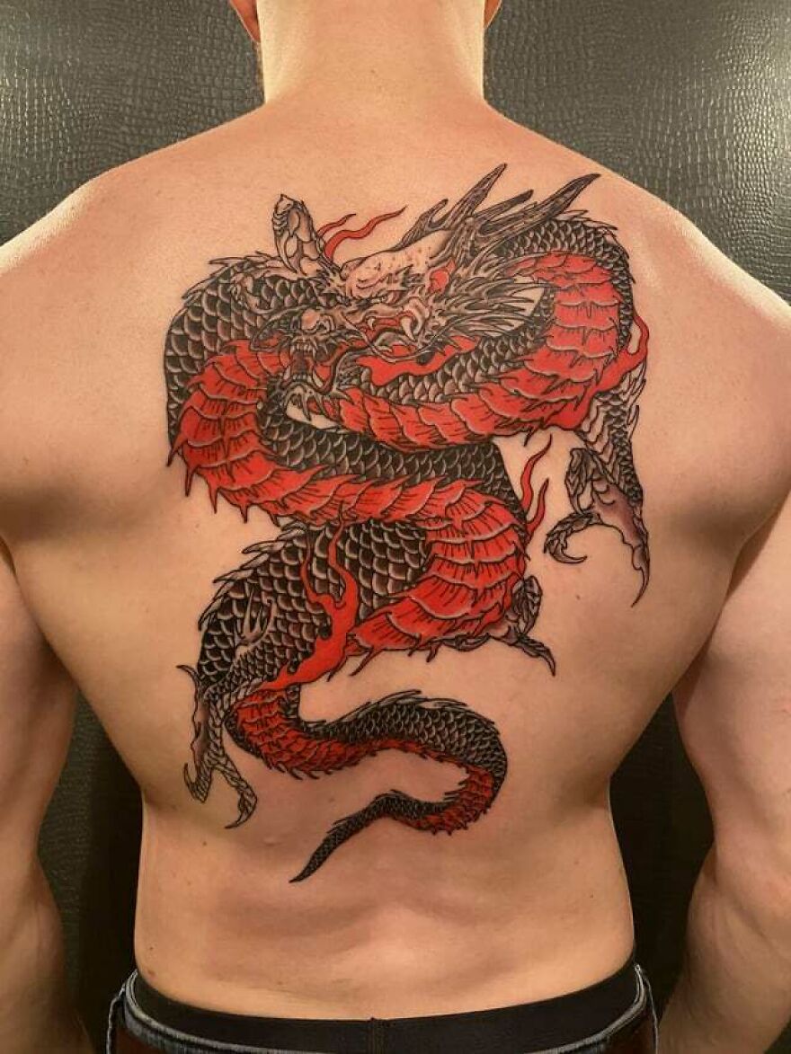 red and black dragon tattoo on back