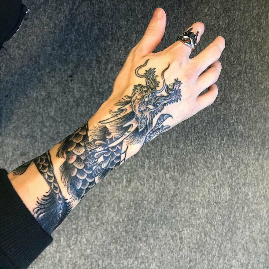 roaring dragon tattoo on forearm and back of the palm