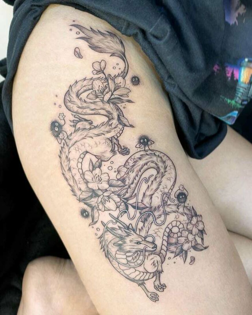 tattoo of a black ink haku surrounded by flowers and tiny black balls
