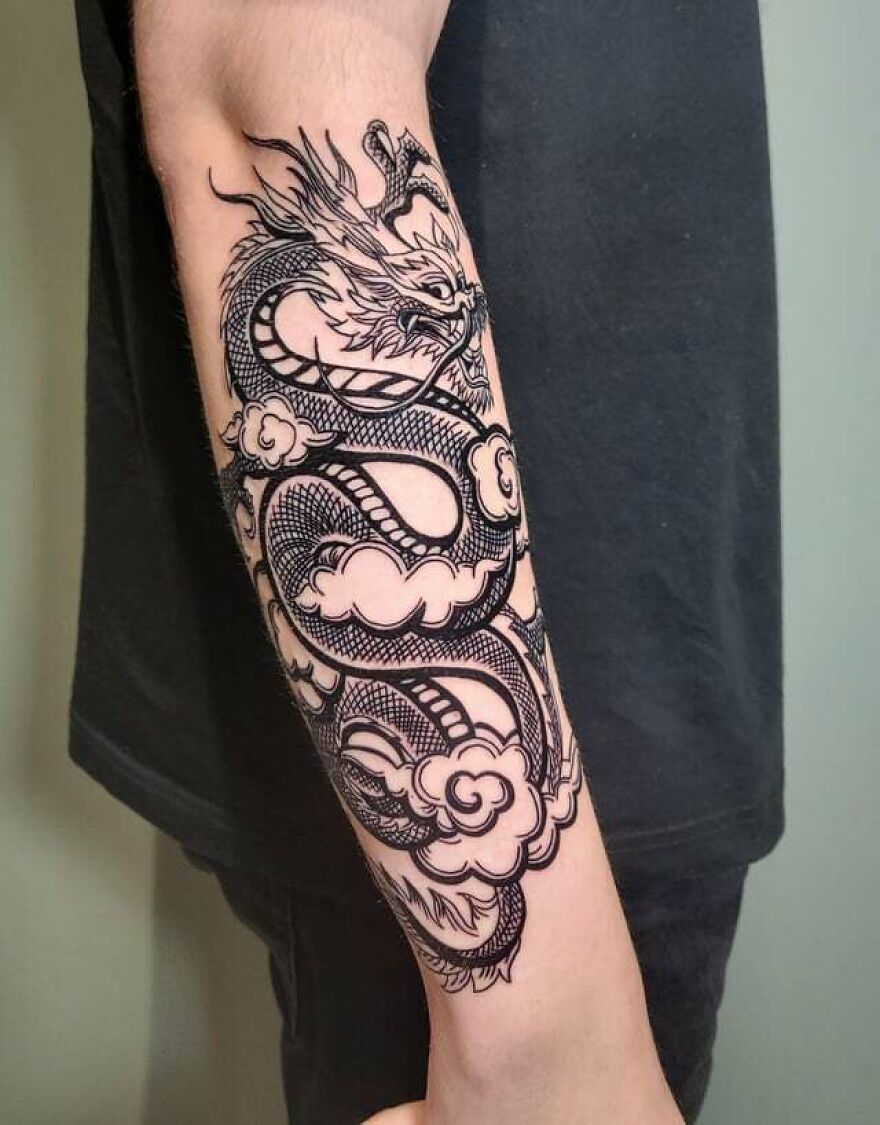 Neat Black Ink Tattoo Of A Dragon And Clouds On Forearm