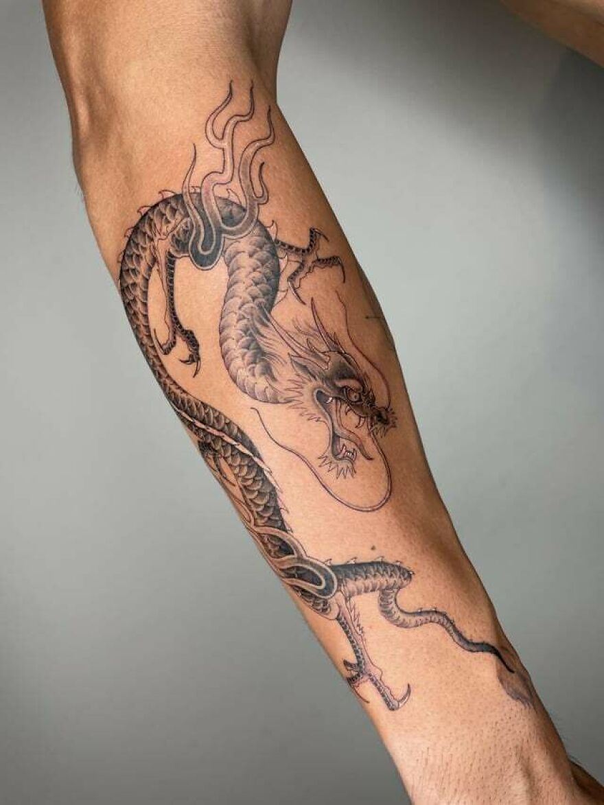 detailed tattoo of a chinese dragon in a attacking stance