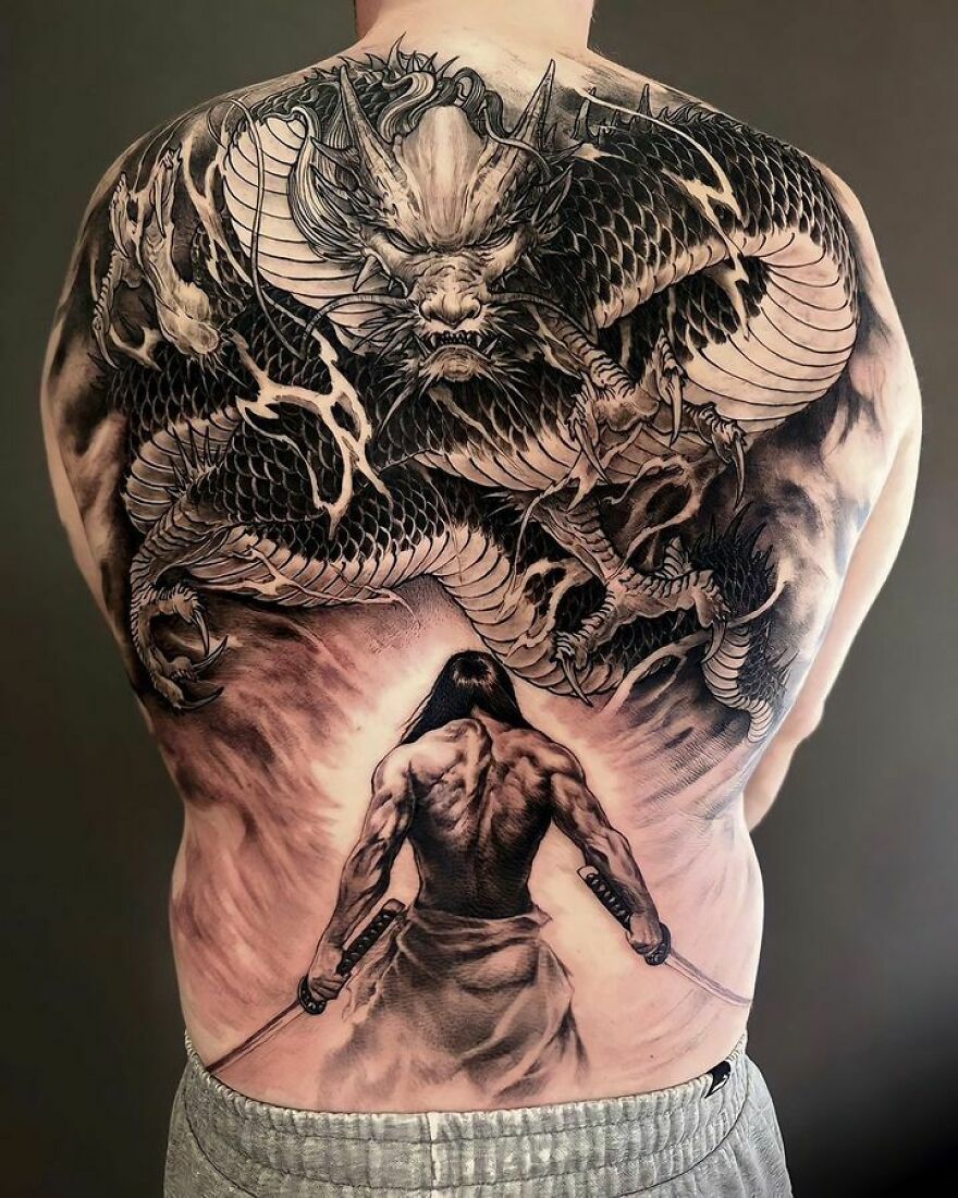Black ink back tattoo of a dragon and a warrior with swords
