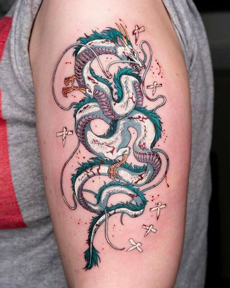 a multicolored tattoo of a haku dragon on bicep