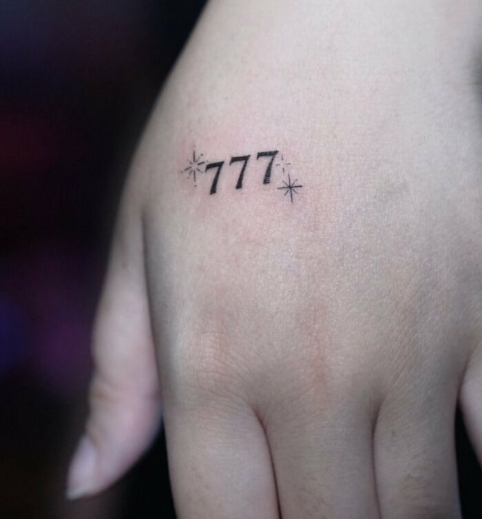 ‘777’ tattoo on hand