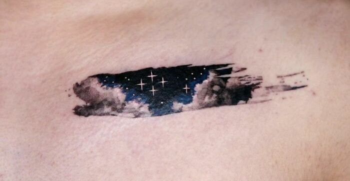 Starry night sky with clouds paint smear type Tattoo