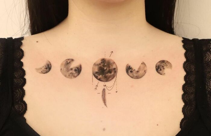 different moon phases chest piece tattoo
