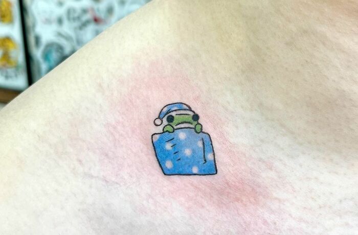 Tiny sleeping Frog On A Collarbone Tattoo