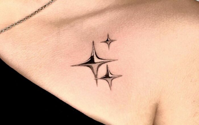 Metal Sparkles Under The Collarbone Tattoo
