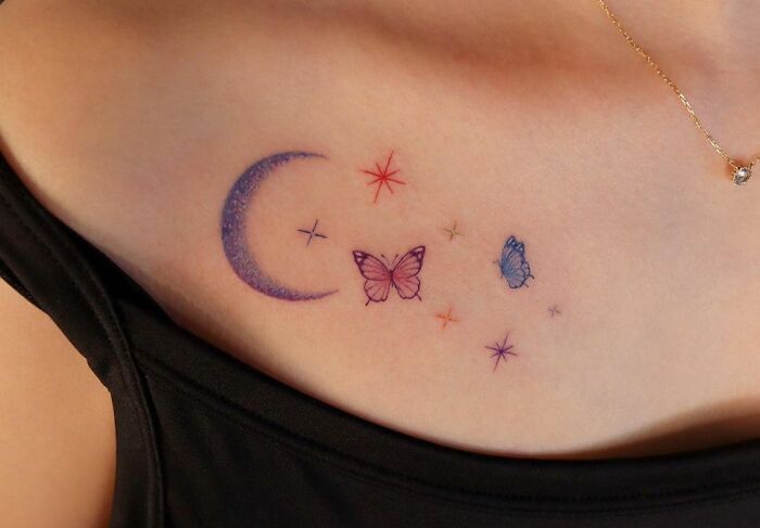crescent moon, butterflies and sparkles coloured collarbone tattoo