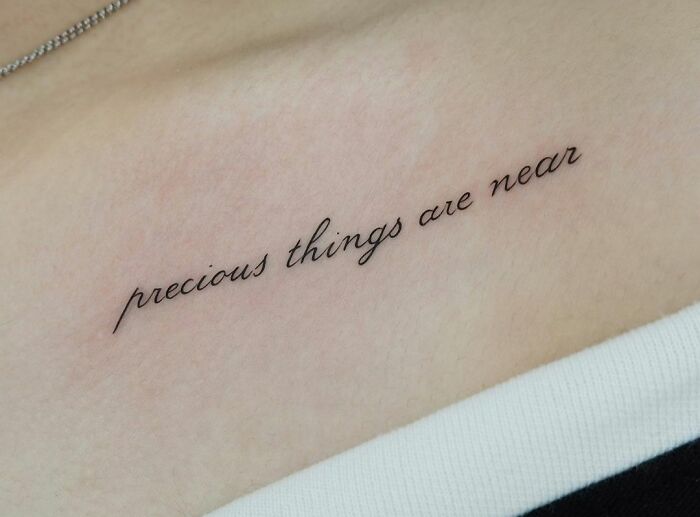 "Precious Things Are Near" lettering collarbone Tattoo
