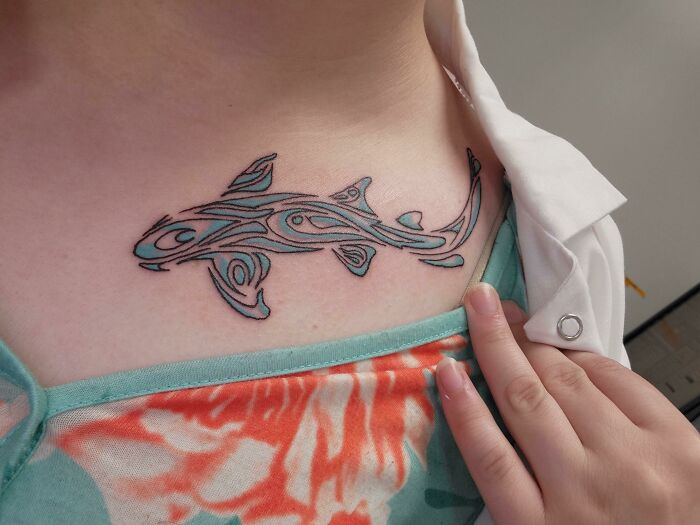Tribal tattoo design of a shark on a person's chest.