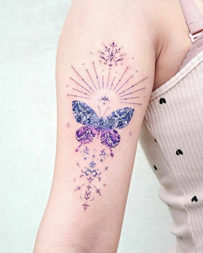 geometrical butterfly arm tattoo