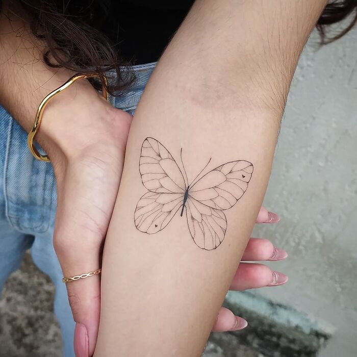 simple butterfly arm tattoo