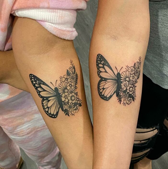 matching butterflies with flowers arm tattoos