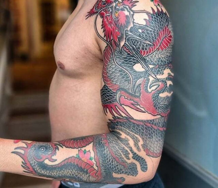 Fire-breathing dragon forearm tattoo