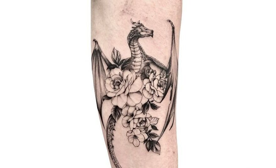 scary dragon tattoo with floral decorations