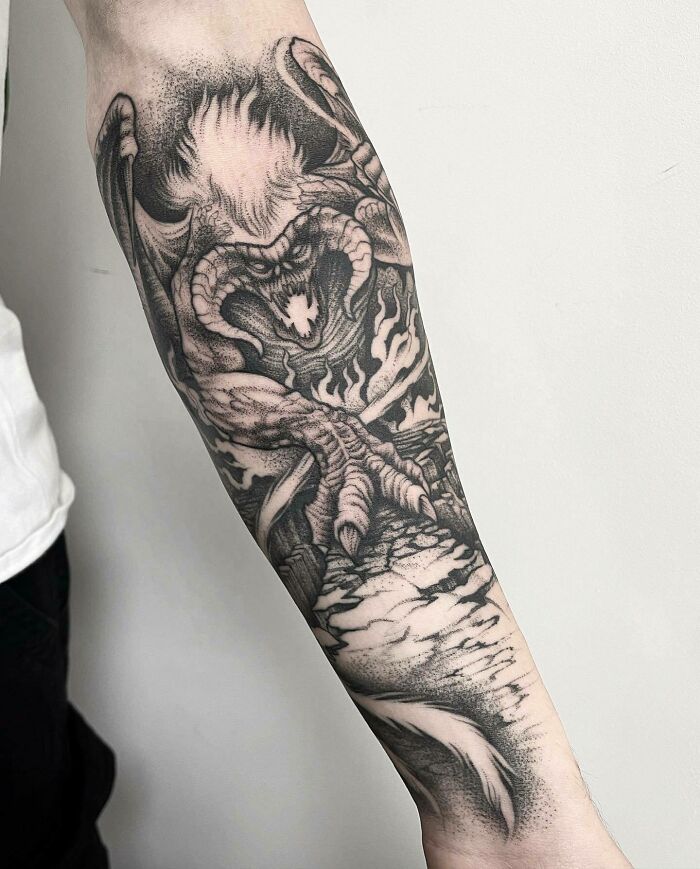 Detailed black and white tattoo of a Balrog on forearm, inspired by Lord of the Rings.