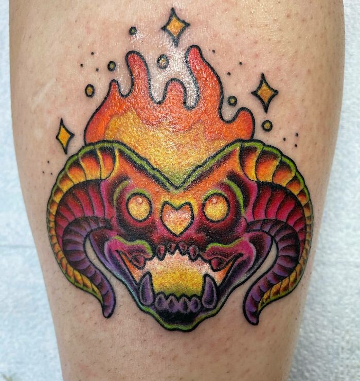 Barlog's head in flames tattoo